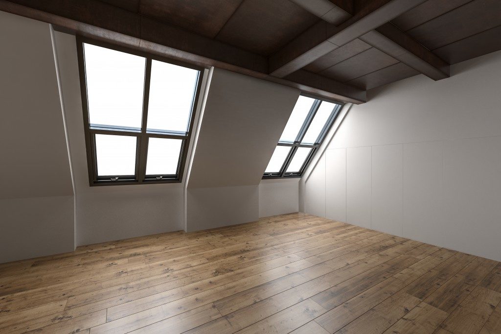 attic with hardwood flooring