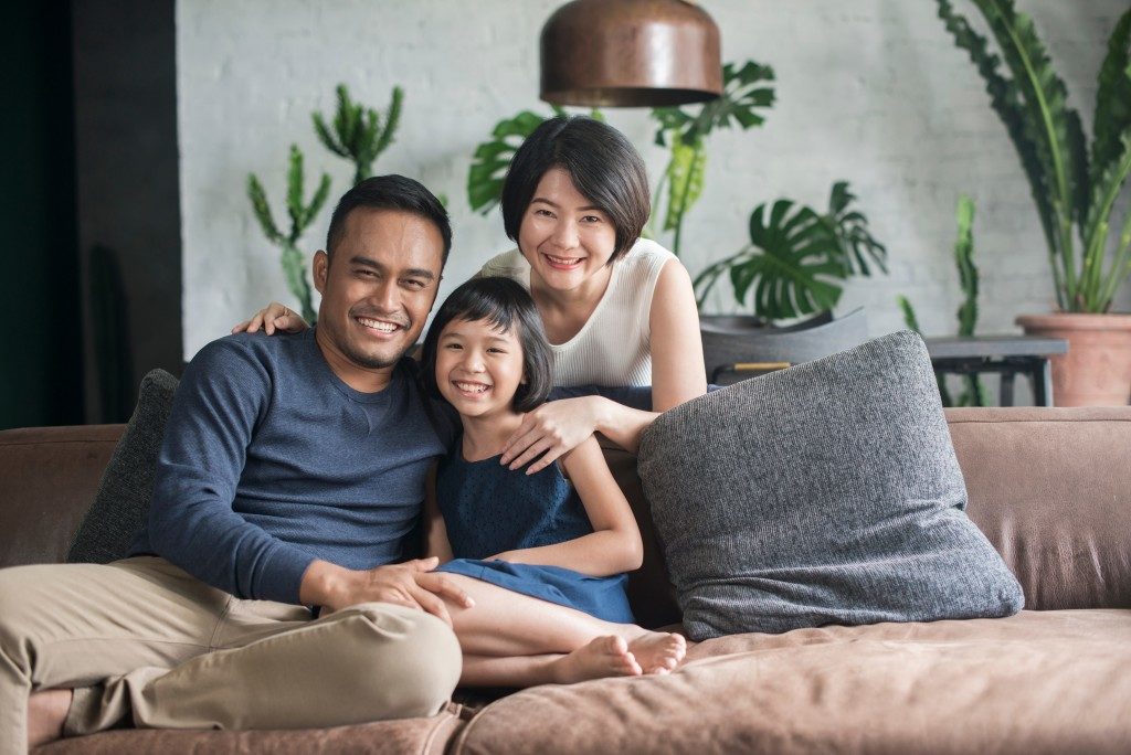 parents and child on the sofa