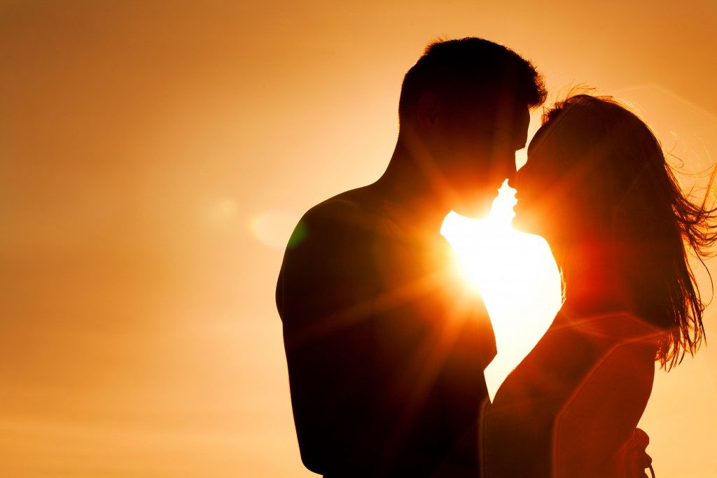 Couple kissing at sunset