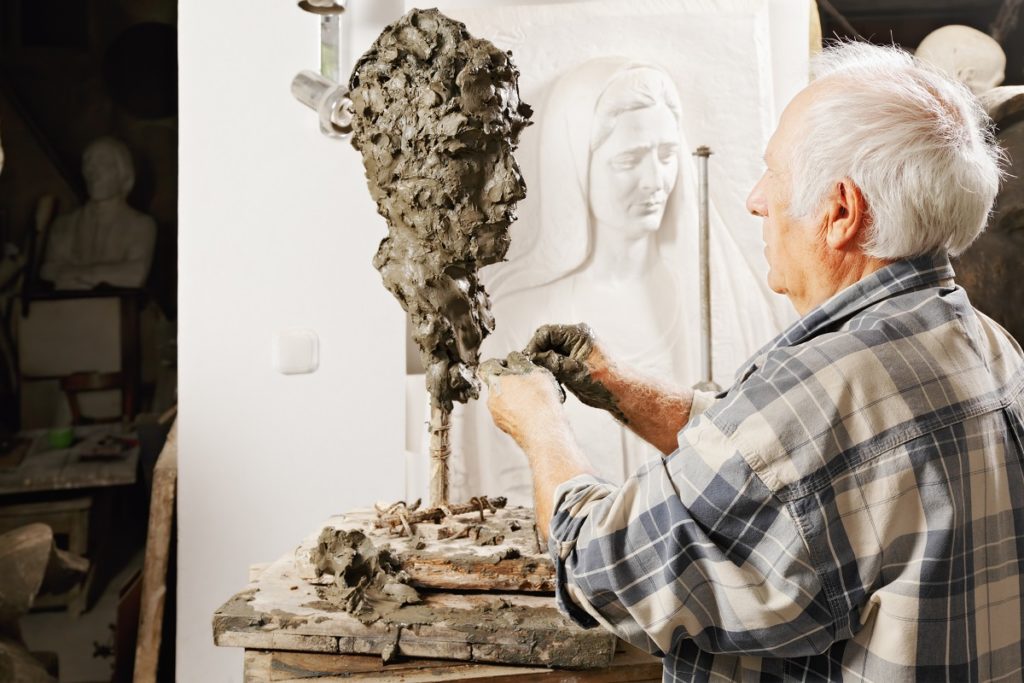 Sculptor creating a piece in the studio