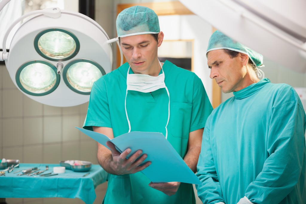 Two surgeons looking at medical records