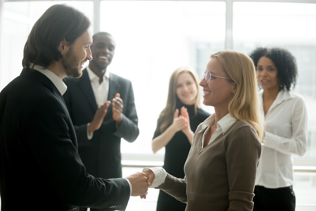 manager shaking hands with employee