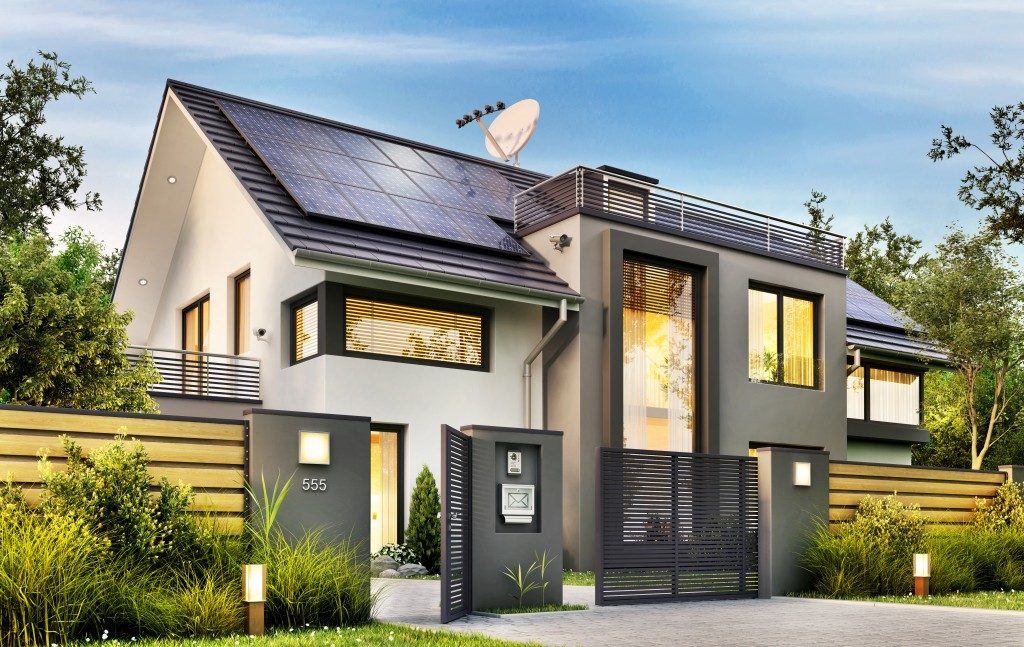 large home with solar panels and garden