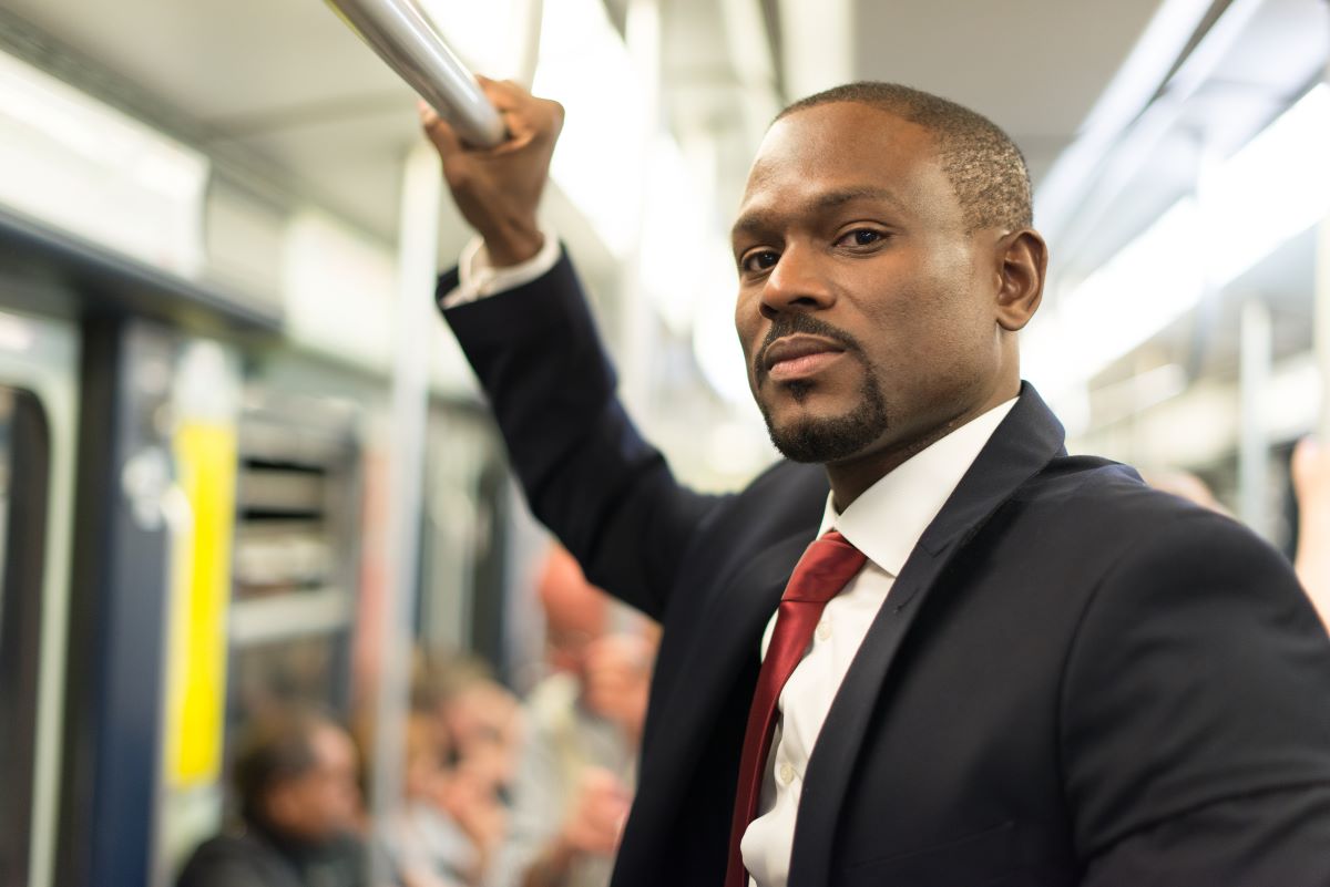 man riding light rail transit