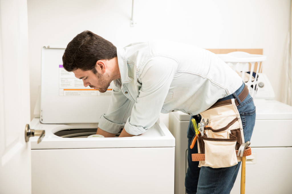 man fixing washing machine