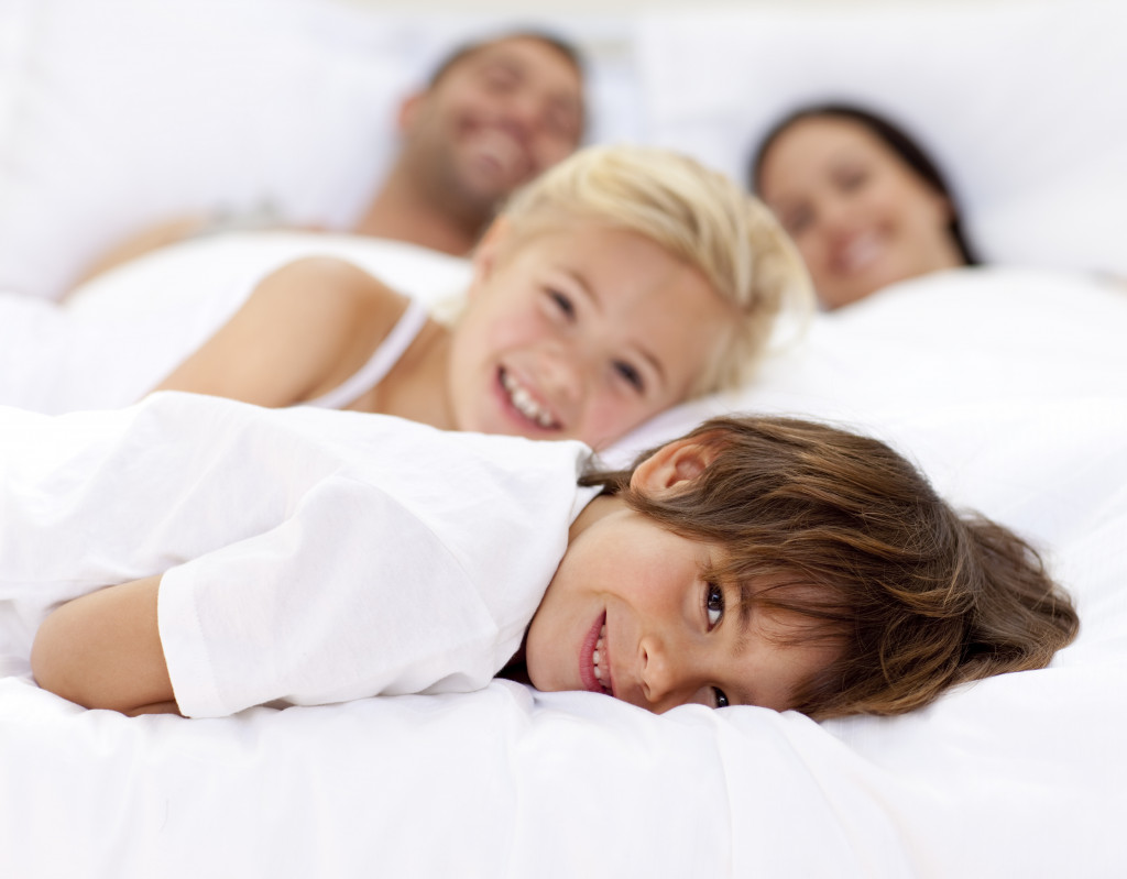 family relaxing on a bed