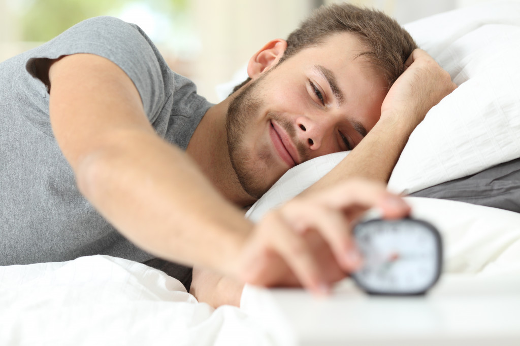 man waking up from alarm