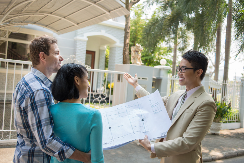 agent showing couple a house for sale