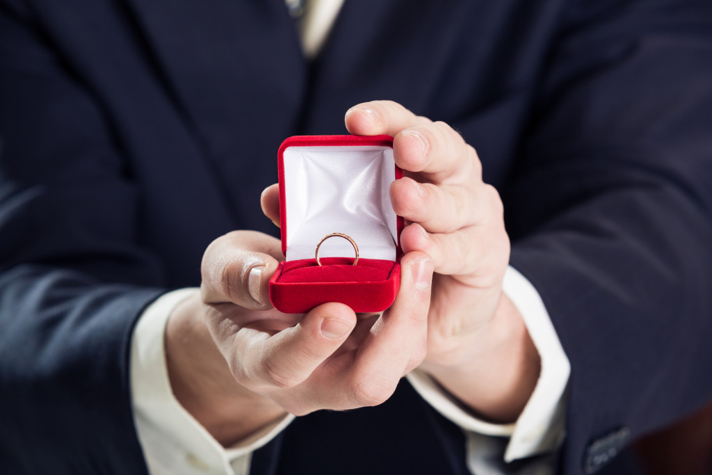 man holding an engagement ring for a proposal