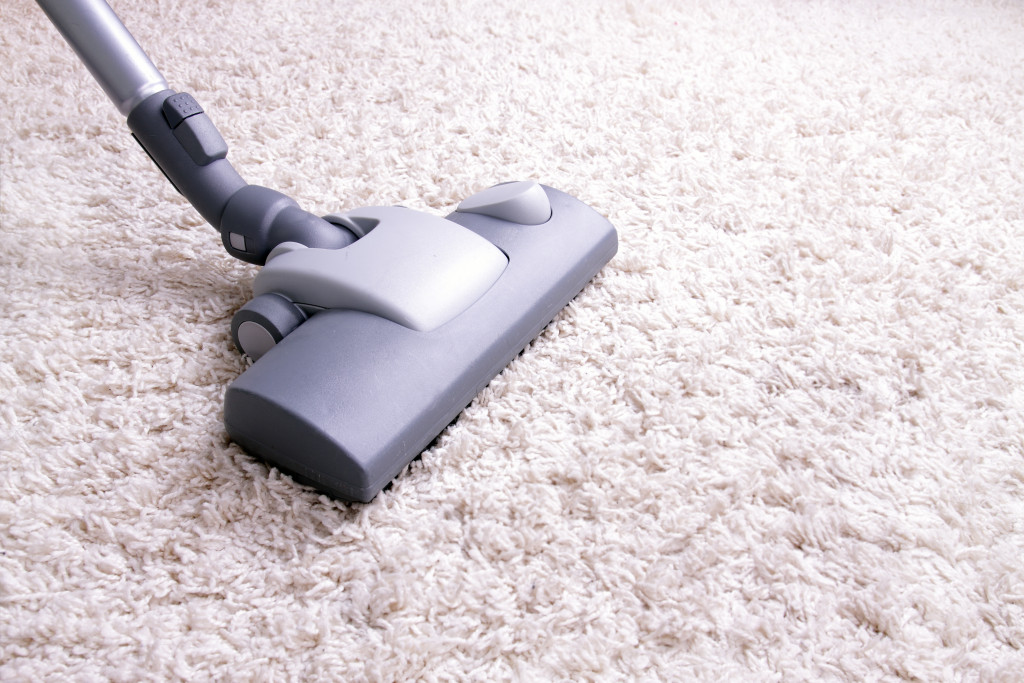 Focus on vacuum on a carpeted floor