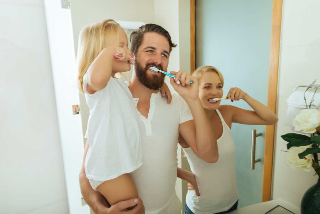 Portrait of a family brushing their teeth together in morning 