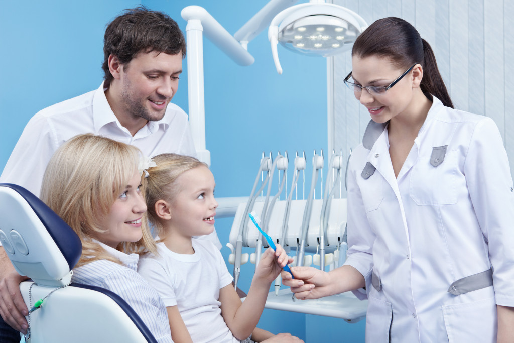 A child at the dentist gets a toothbrush