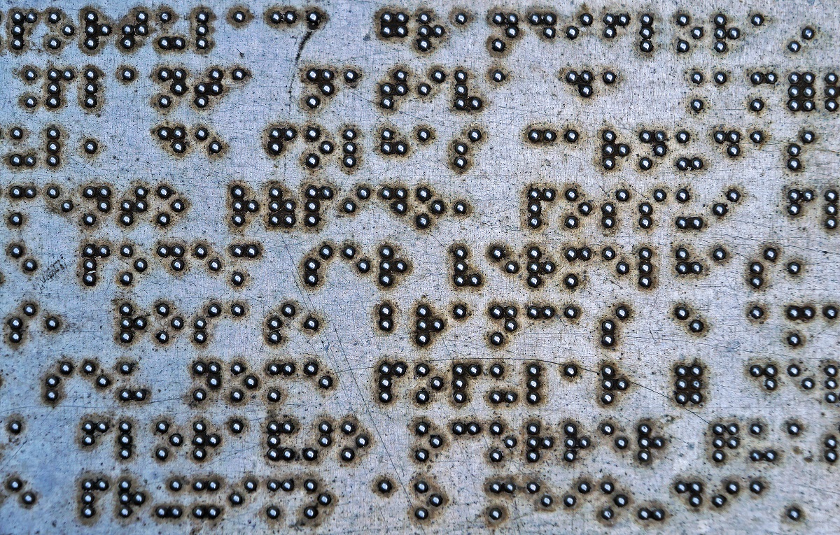 metal plate written in Braille letters