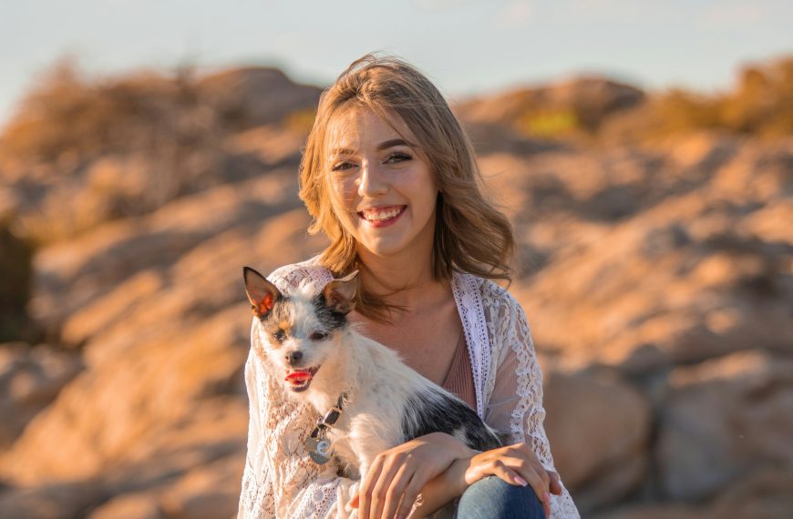 smiling woman hugging her pet dog