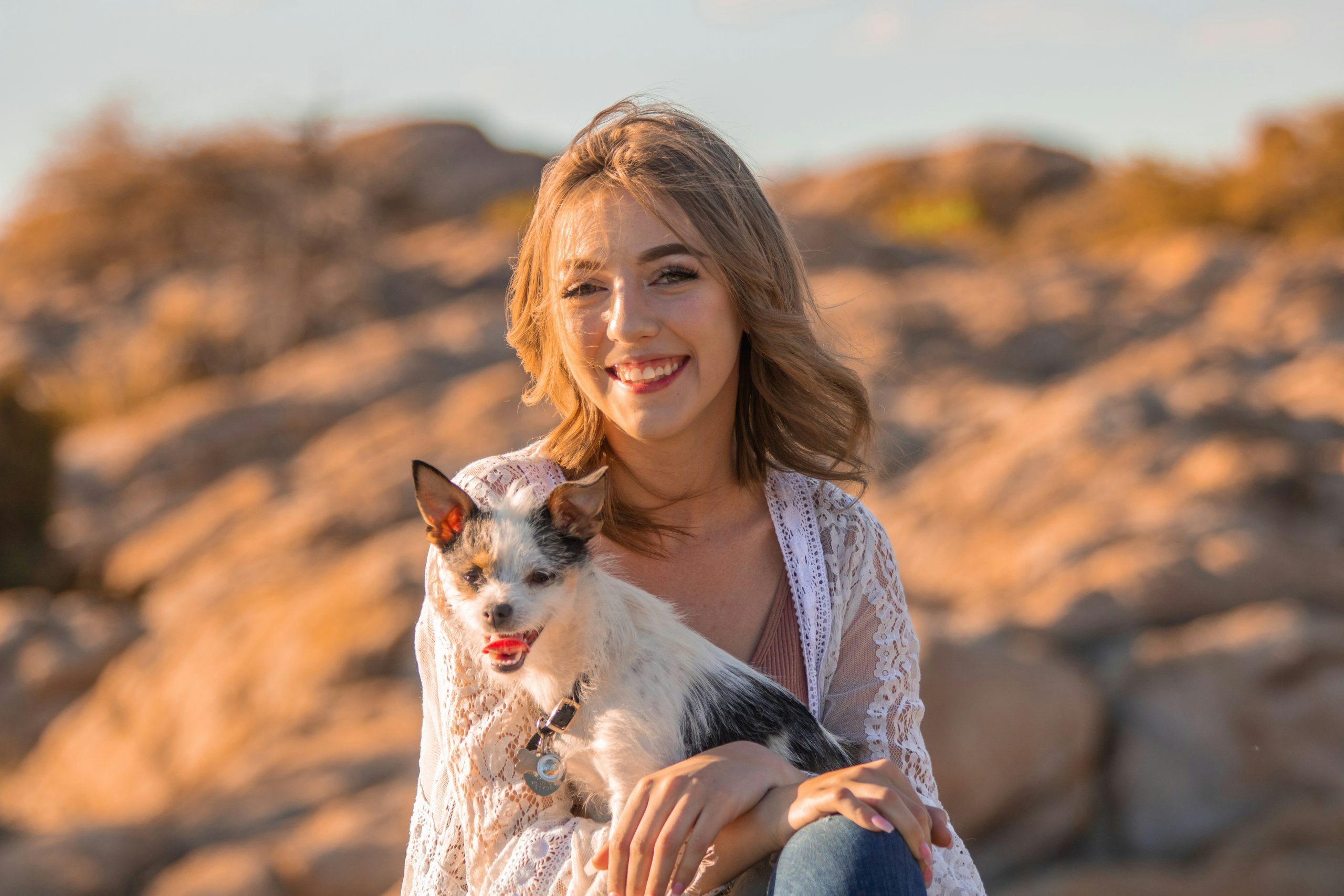 smiling woman hugging her pet dog