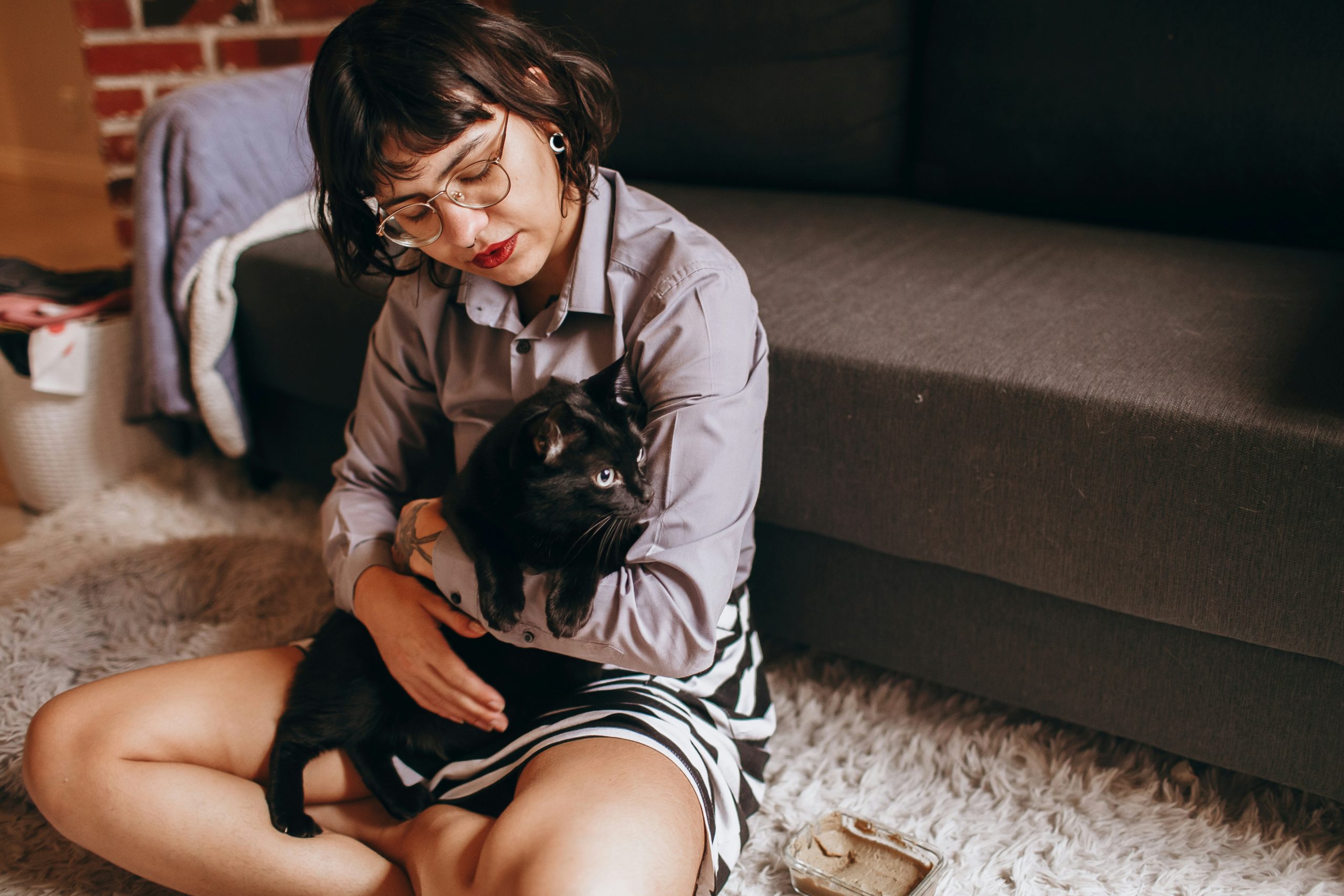 woman hugging her pet cat